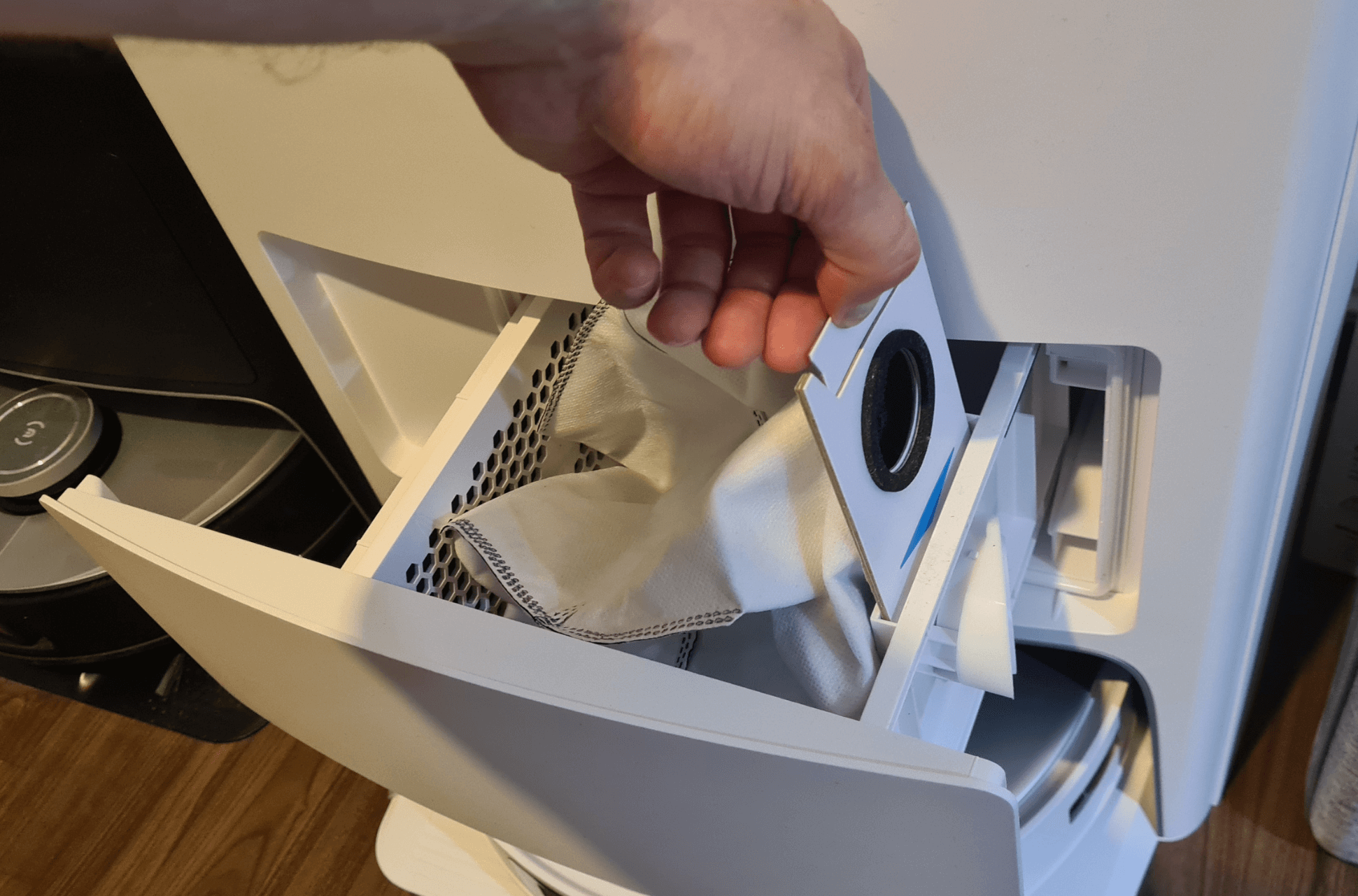 Der Einwegbeutel in der Absaugstation eines Saugroboters wird ausgetauscht.